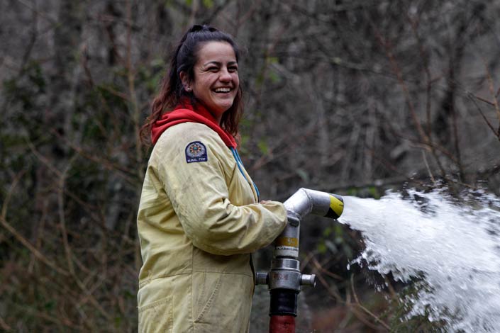 conservation student with fire hose training for fires in distant locations